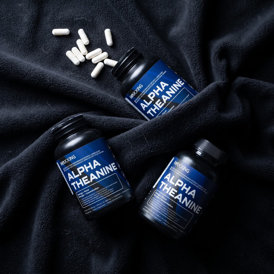 Three Alpha Theanine bottles with capsules on black